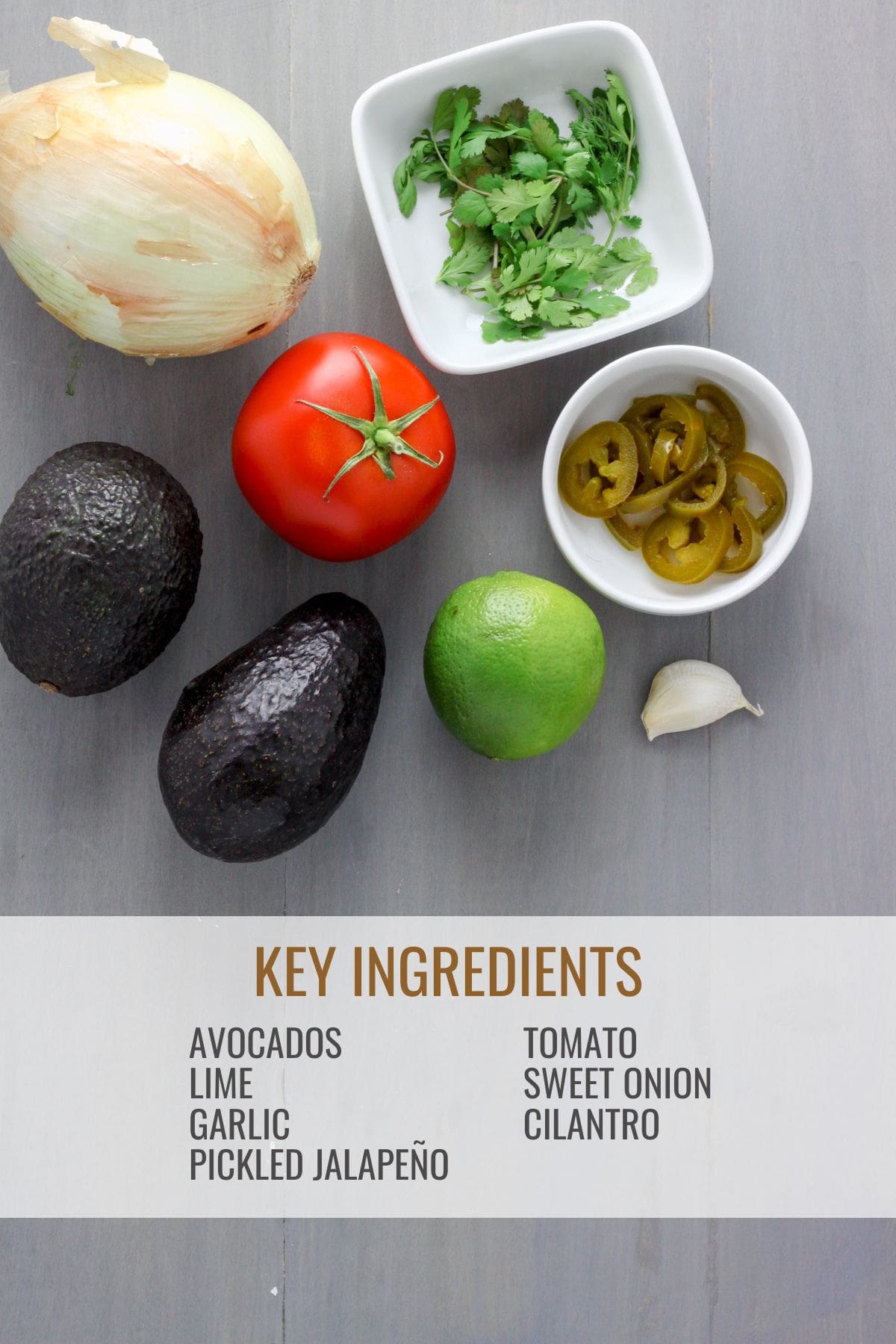 A gray table with ingredients for guacamole with pico de gallo.