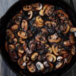 A cast iron skillet with caramelized mushrooms and onions.