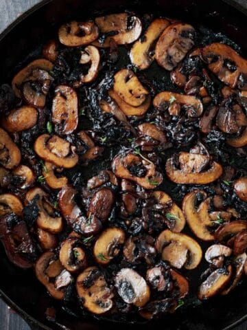 A cast iron skillet with caramelized mushrooms and onions.