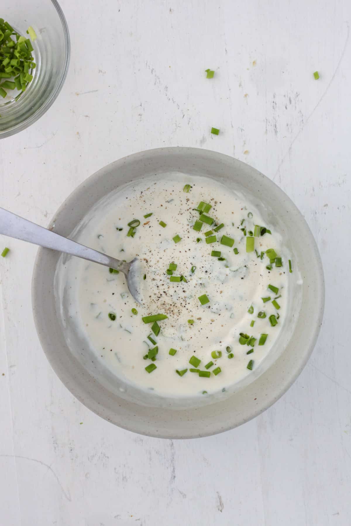 Homemade ranch dressing in a small bowl unmixed.