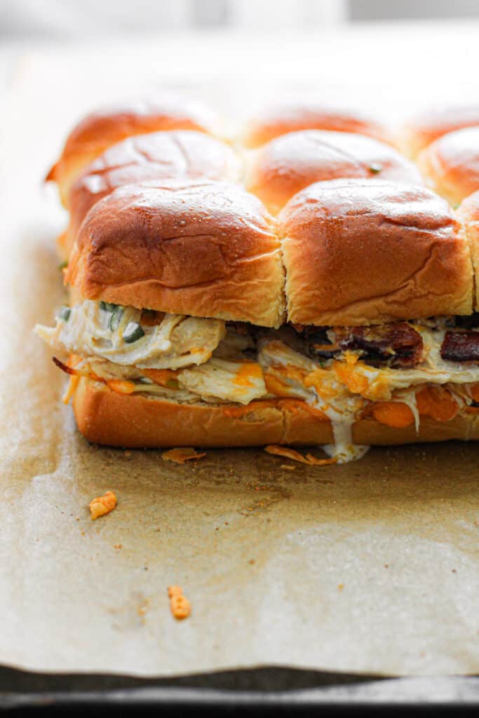 Chicken Bacon Ranch Sliders on a parchment lined baking sheet.
