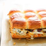 chicken bacon ranch sliders on a parchment lined baking sheet.
