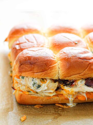 chicken bacon ranch sliders on a parchment lined baking sheet.