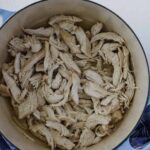 A Dutch oven with pulled chicken.