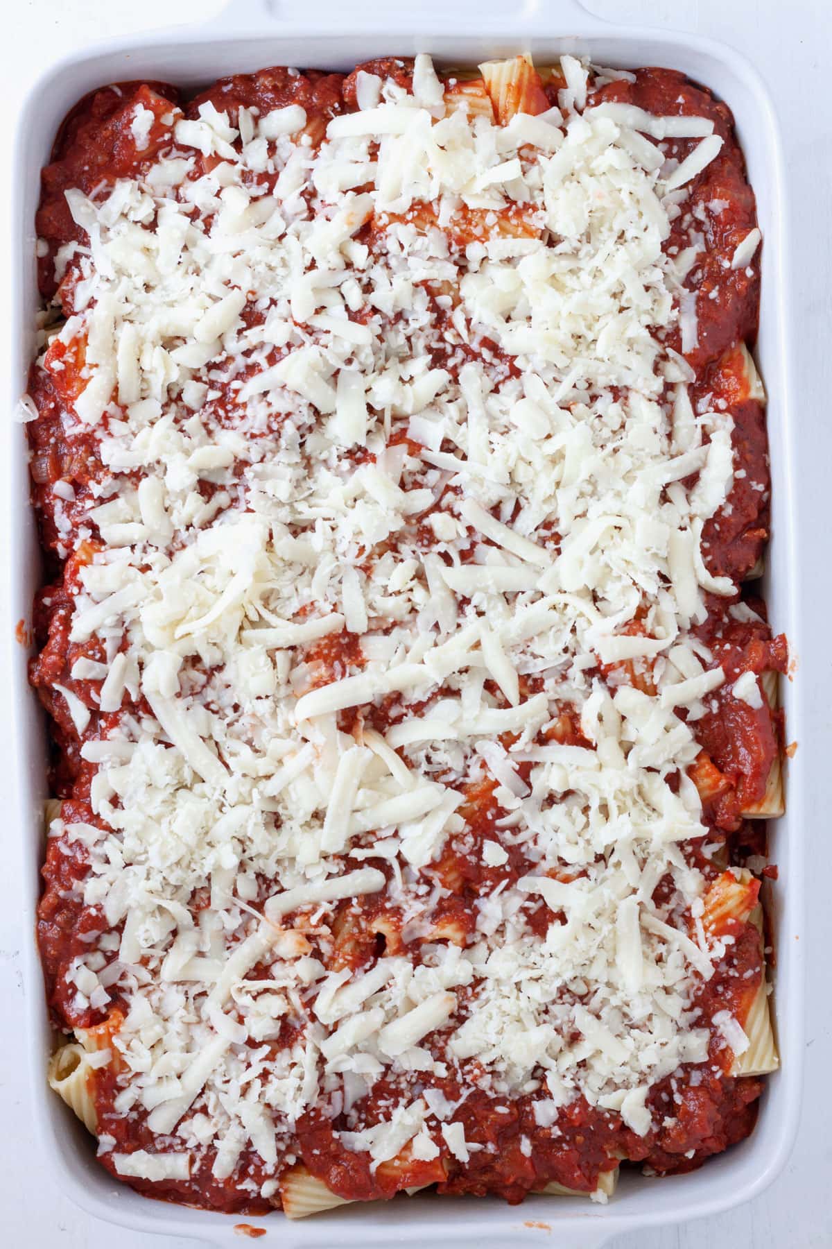 Rigatoni al forno in a baking dish uncooked.