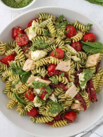 A large bowl of tuna pesto pasta.