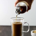 Brown Sugar Simple Syrup pouring into a coffee drink.