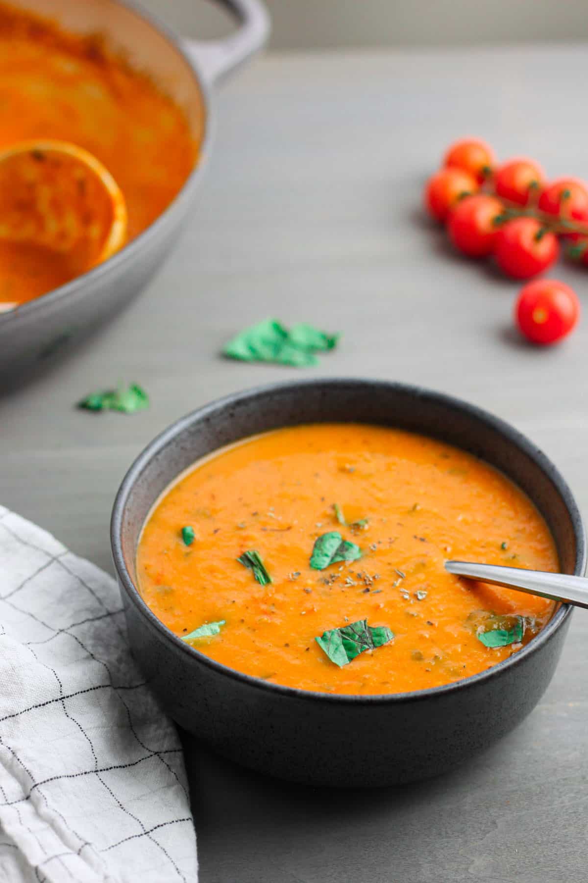 A gray bowl of roasted cherry tomato soup.
