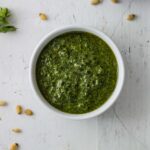 A small bowl of homemade basil pesto.