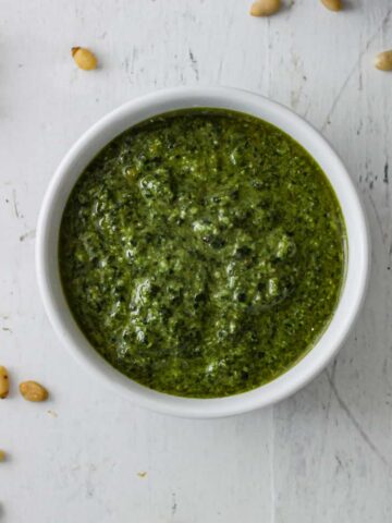 A small bowl of homemade basil pesto.