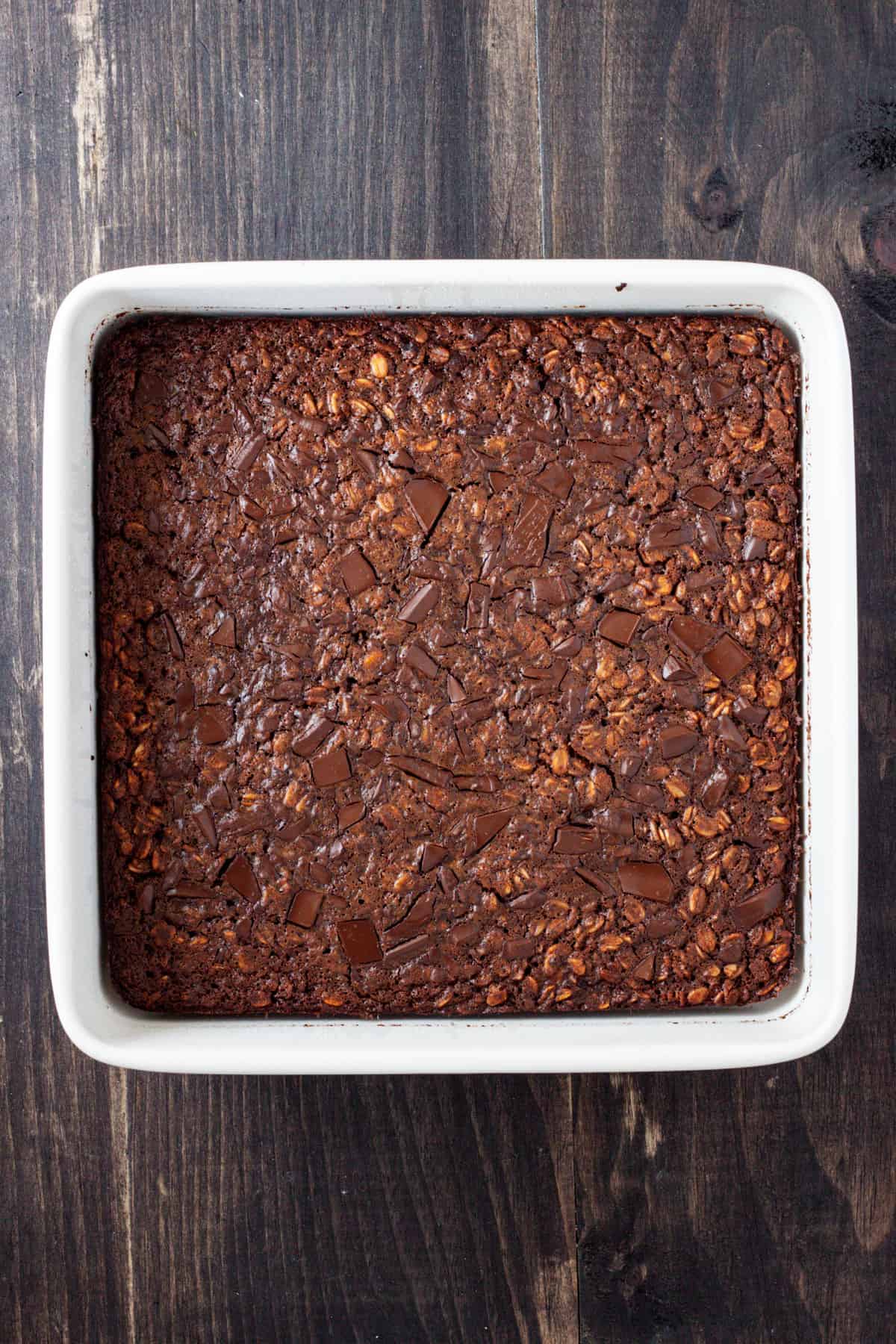 Chocolate baked oatmeal cooked and set in a square baking dish.