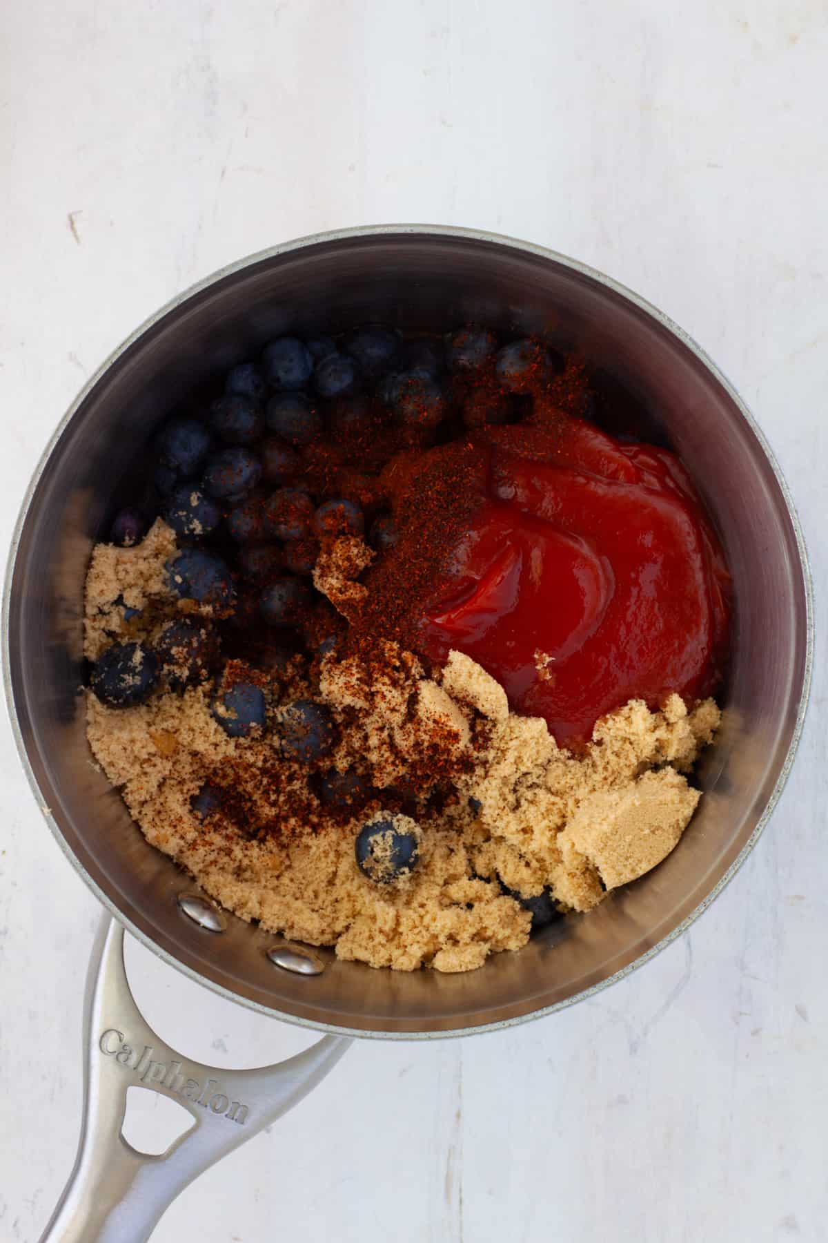 Ingredients for blueberry bbq sauce in a medium saucepan.