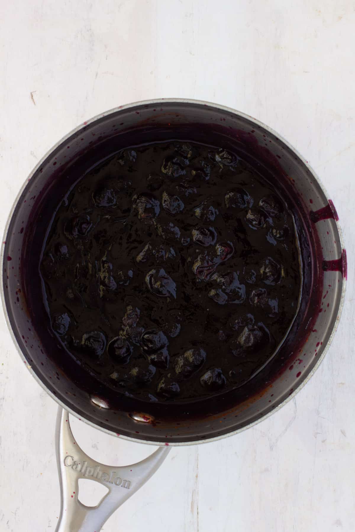 Blueberry bbq sauce cooking in a medium saucepan.