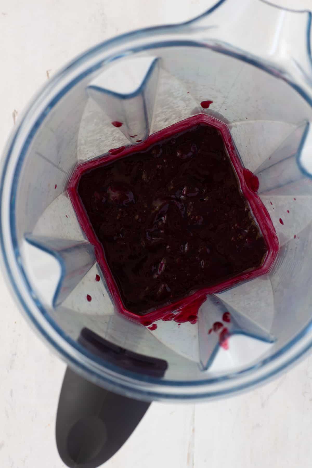 Blueberry BBQ sauce getting pureed in a blender.