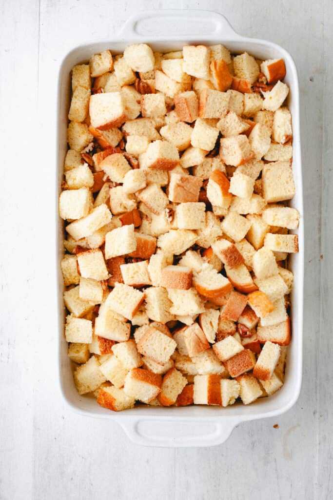 An uncooked brioche french toast casserole in a white baking dish.