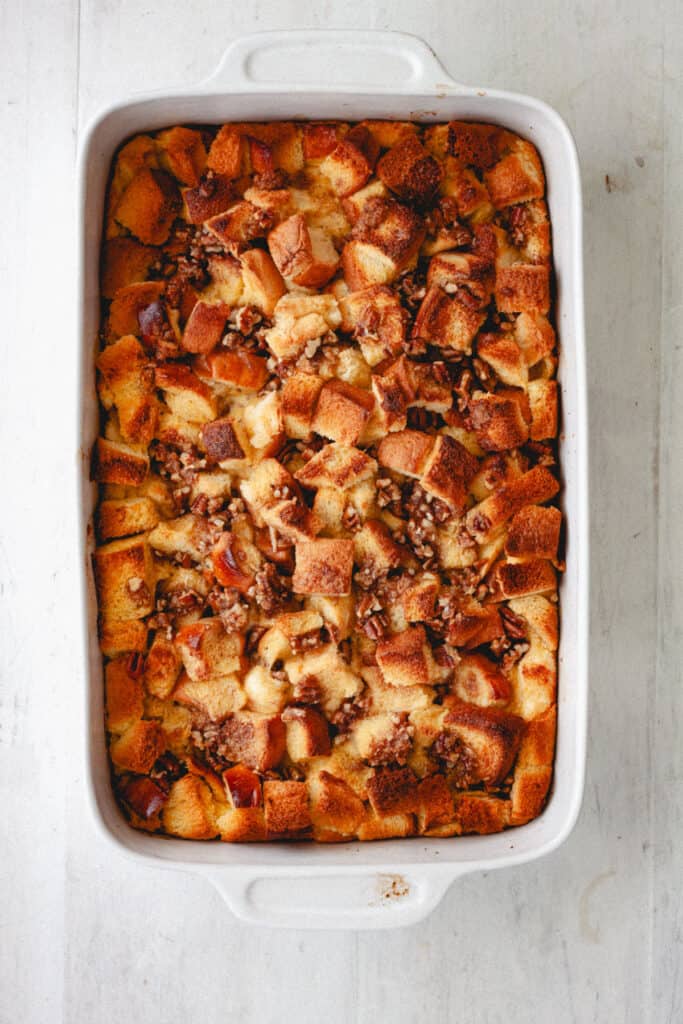 A cooked brioche French toast casserole on a white table.