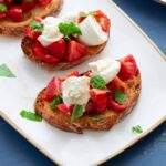 Burrata Bruschetta on a small white plate.