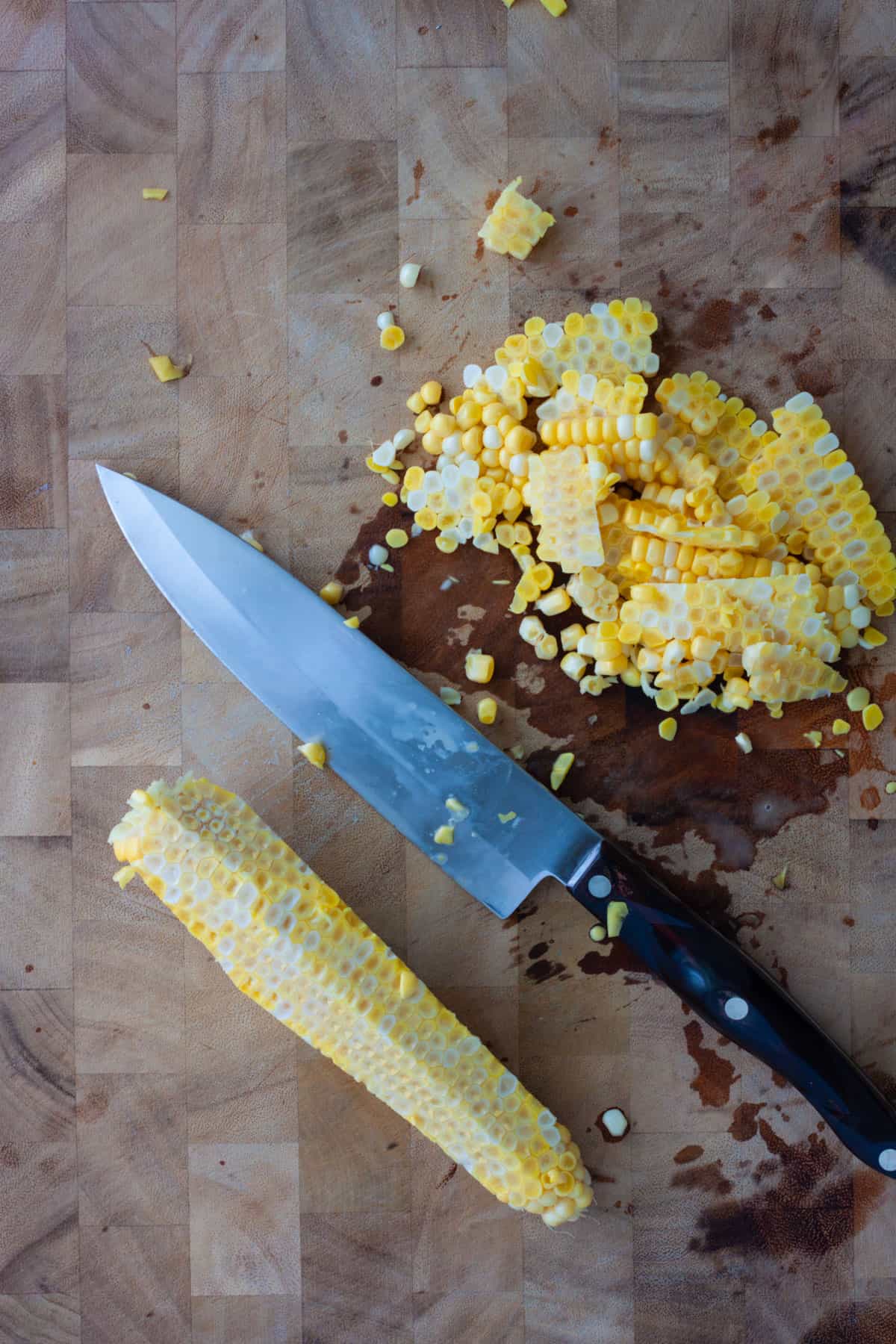 Corn freshly cut off the cob with a chef knife.