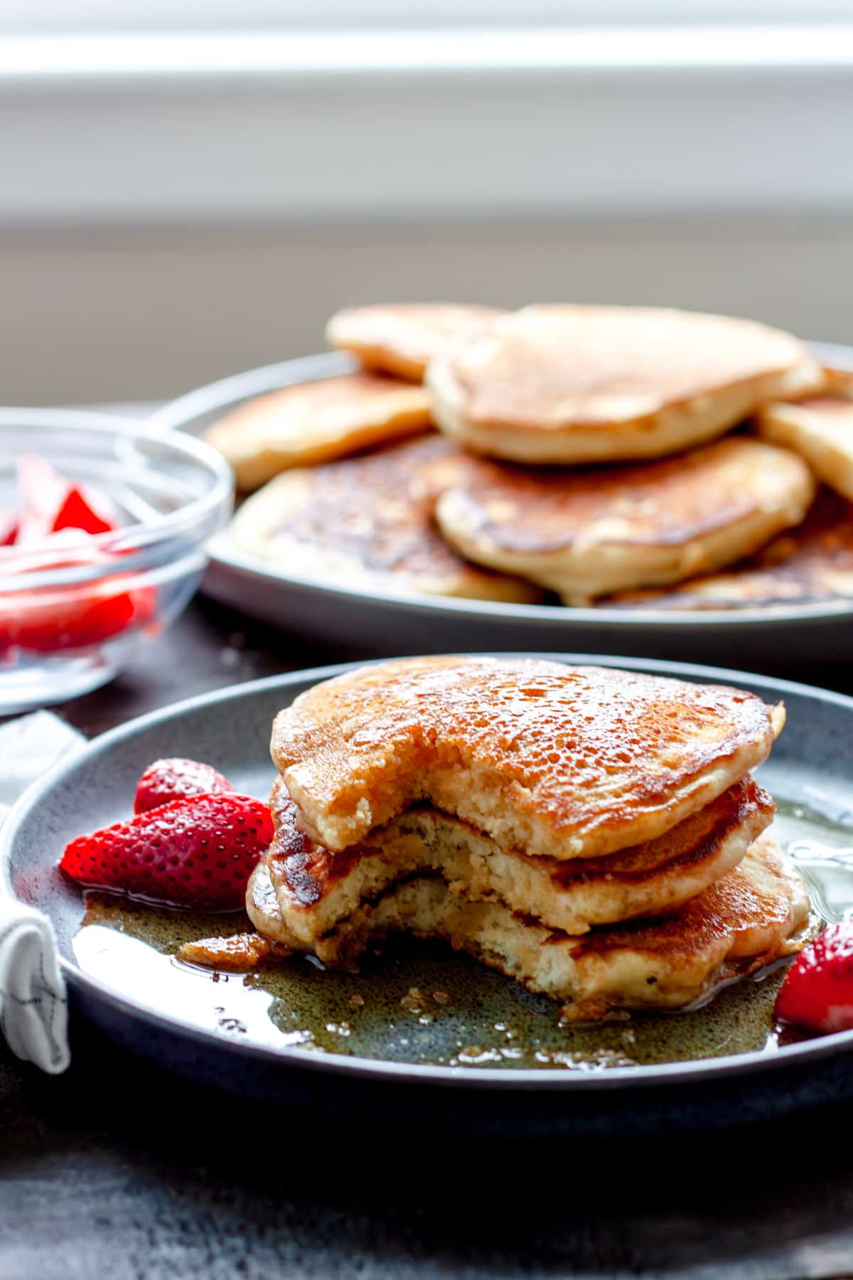 Oat milk pancakes with a bit taken out.