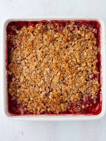 A cooked strawberry crumble in a baking dish.