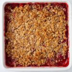 A cooked strawberry crumble in a baking dish.