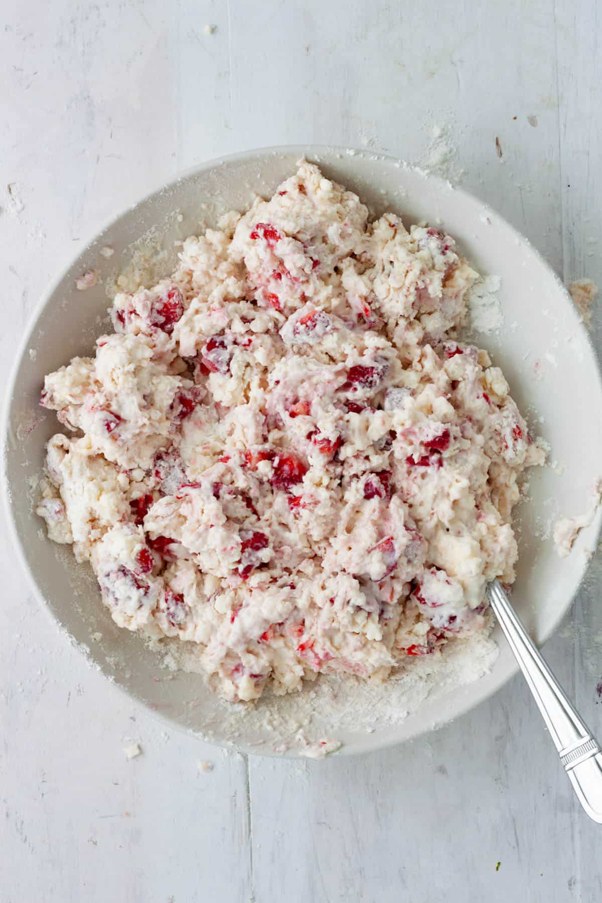 Strawberry biscuit dough in a medium mixing bowl.