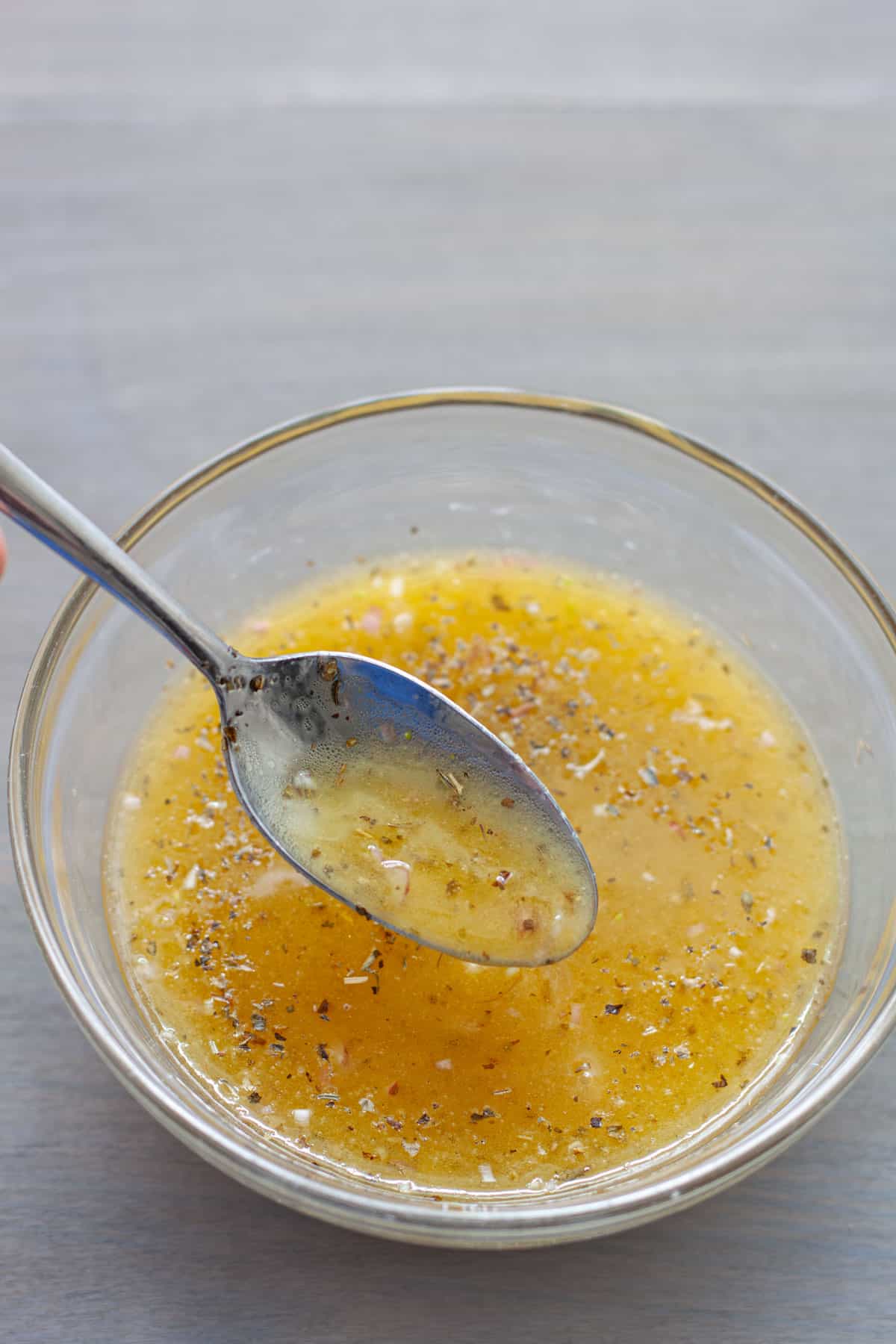 White balsamic vinaigrette in a small bowl with a spoon.