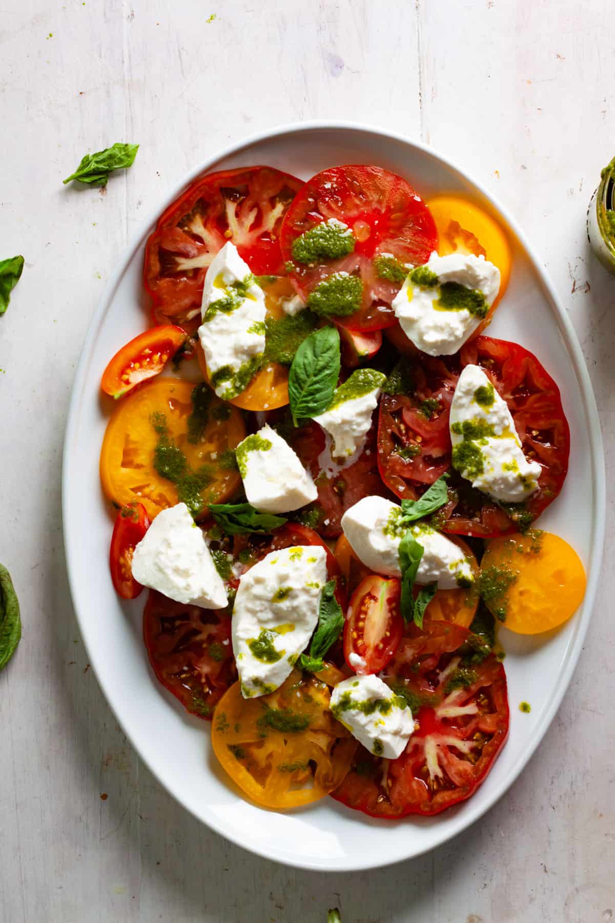 Basil vinaigrette drizzled over a caprese salad.