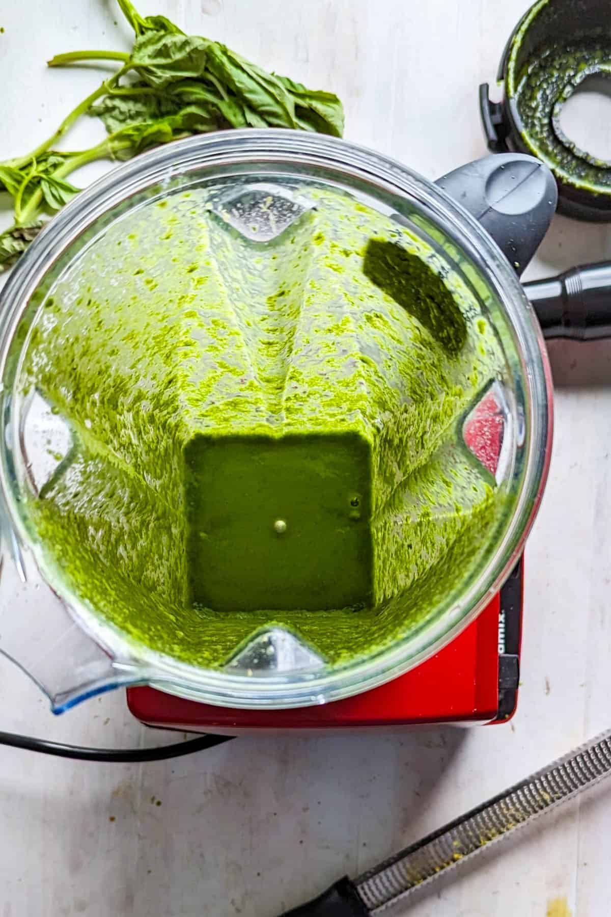 A blended basil vinaigrette in a blender.