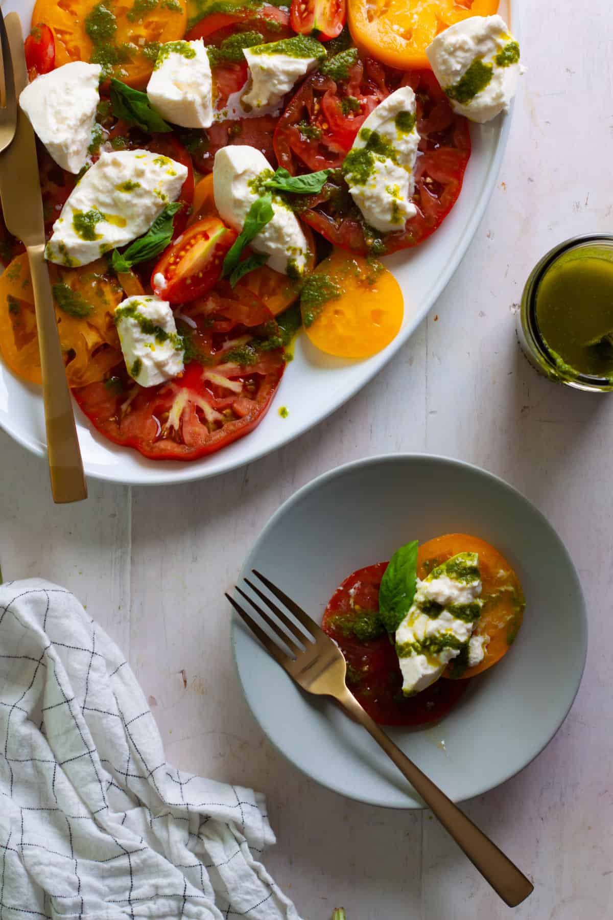 Burrata CAprese Salad with Basil Vinaigrette on a serving platter.