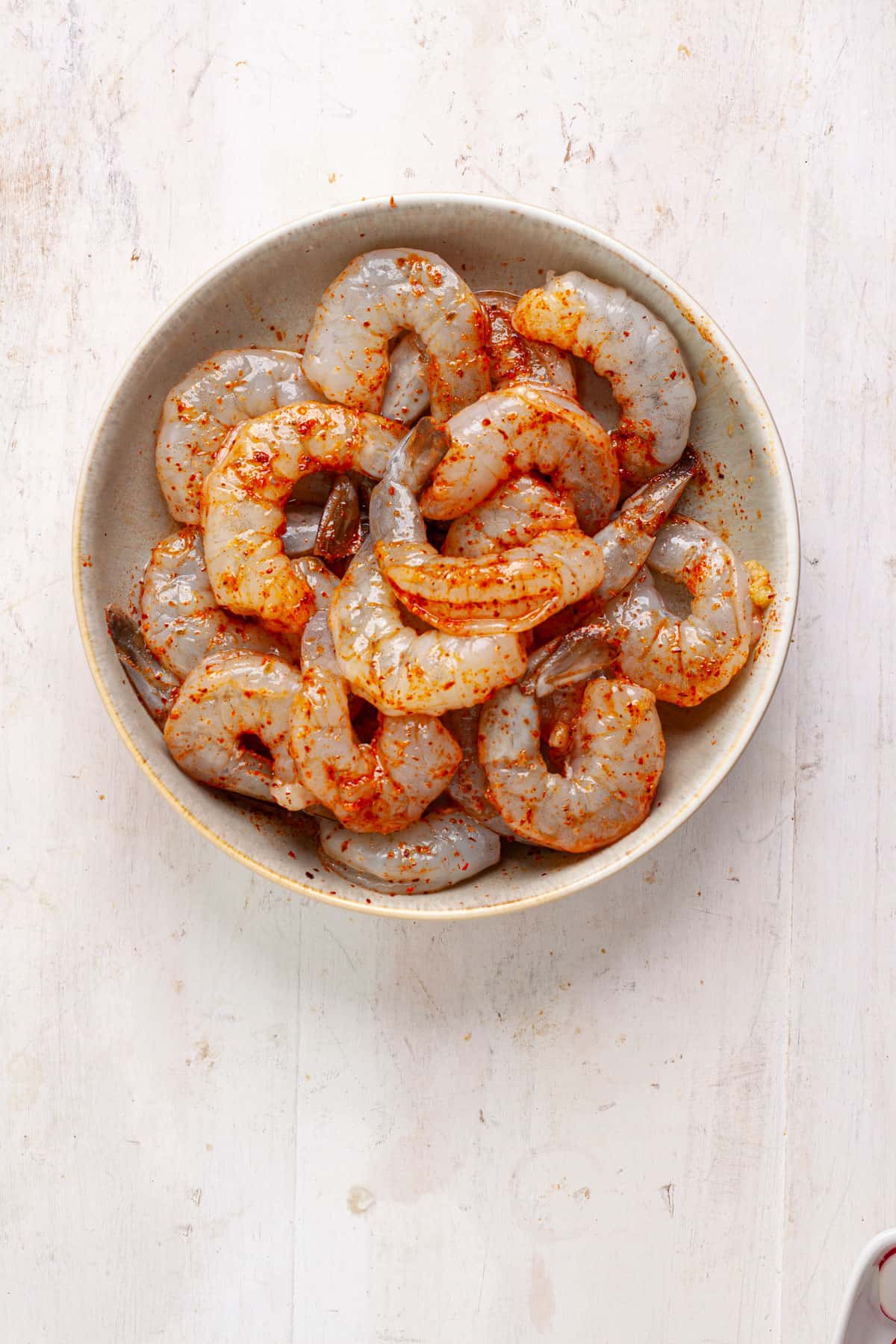 Shrimp marinating with oil, garlic and chili lime seasoning.