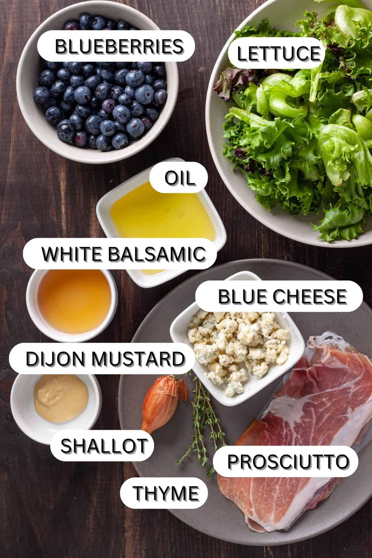 Ingredients for a crispy prosciutto, blueberry and blue cheese salad in a dark table.