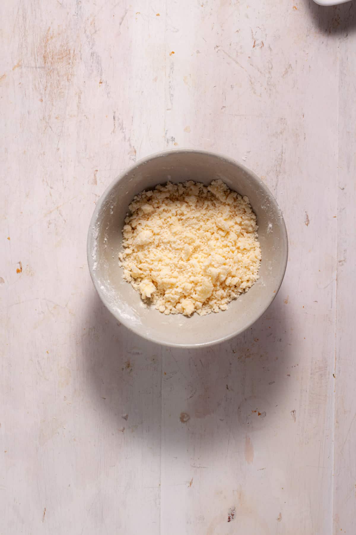 A streusel topping in a small mixing bowl.