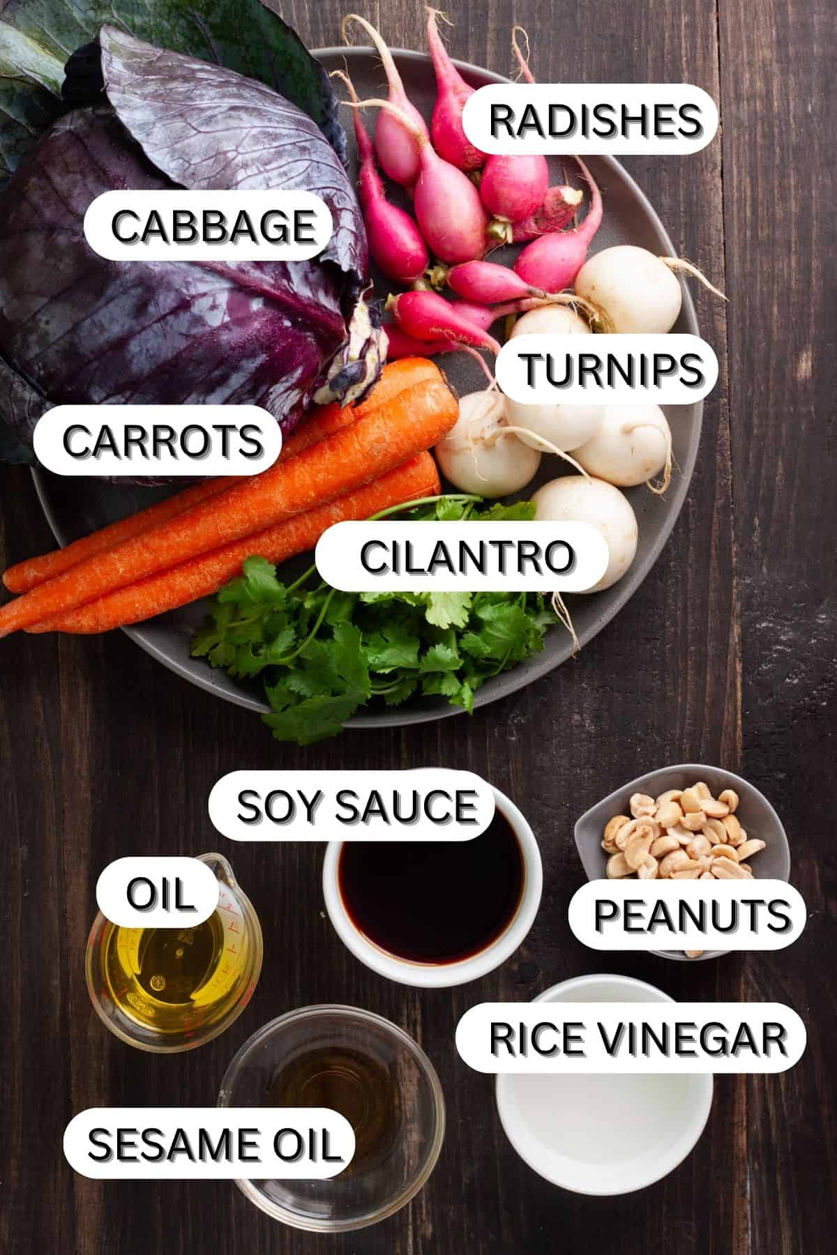 Ingredients for purple cabbage slaw on a dark table.