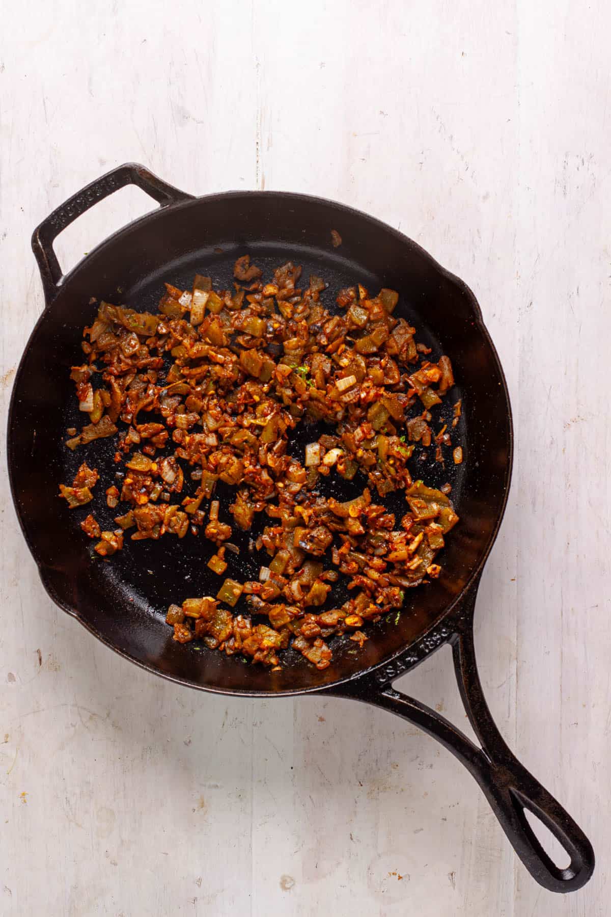 Onion, garlic and spices in a cast iron skillet.