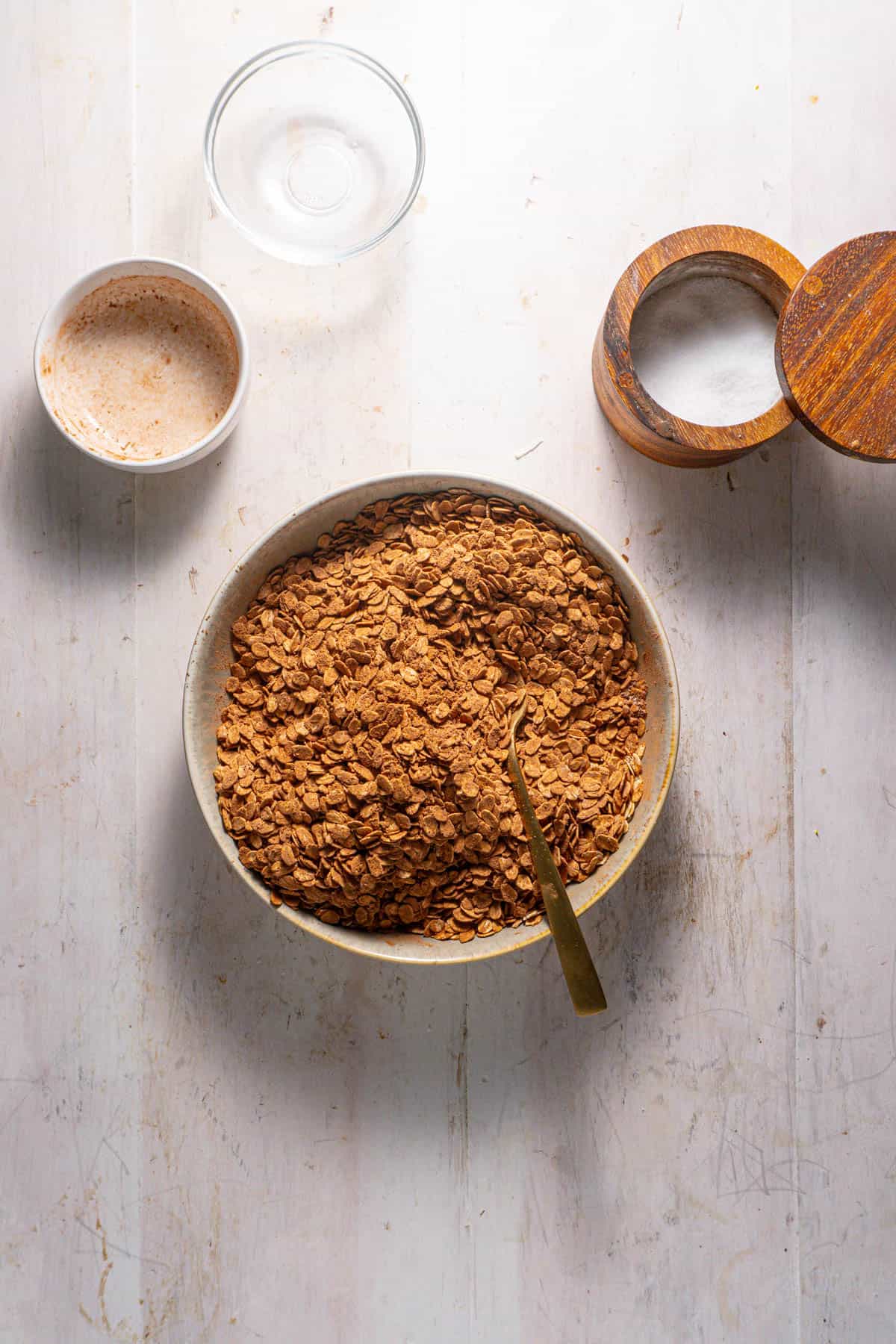 Oats and cocoa powder mixing together in a bowl for a german chocolates baked oatmeal.