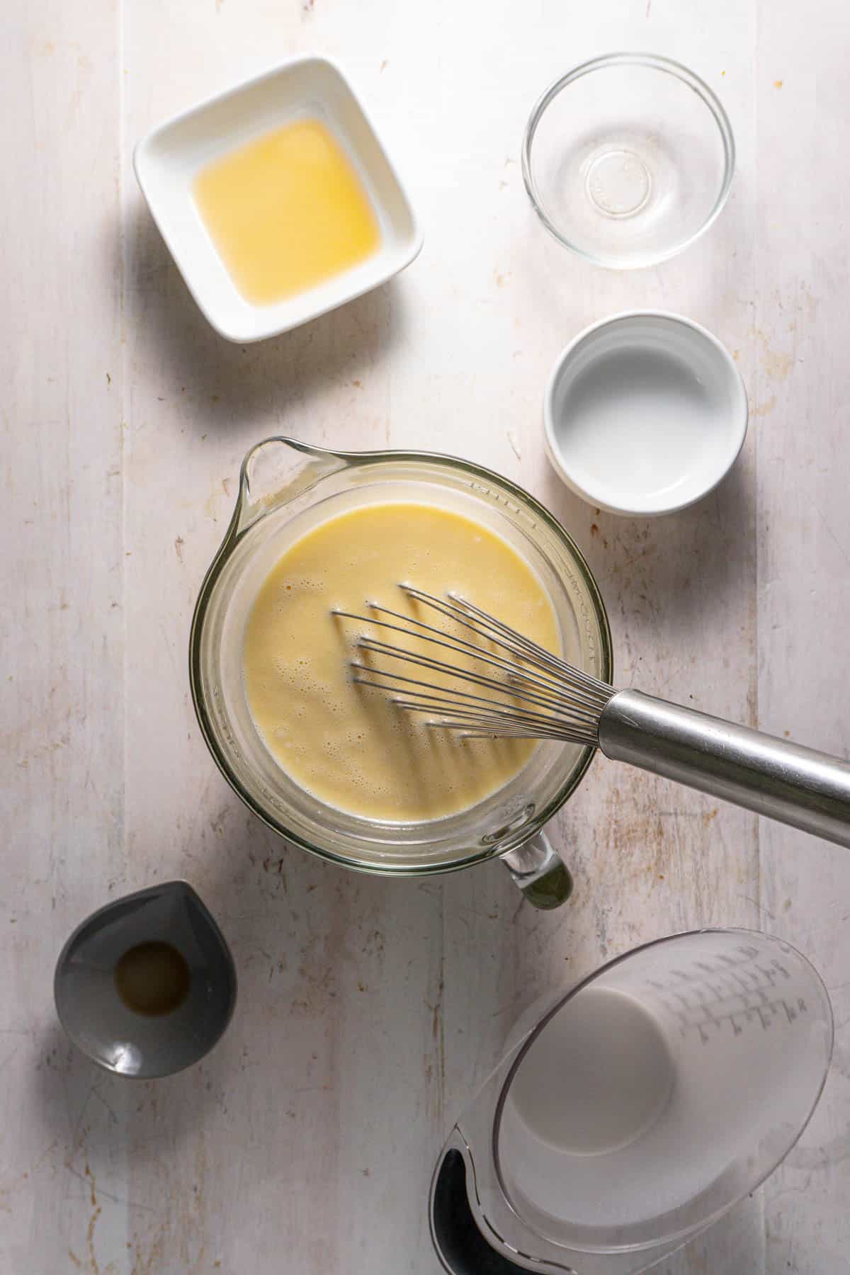 The wet ingredients of a german chocolate cake baked oatmeal mixed together in a measuring cup.
