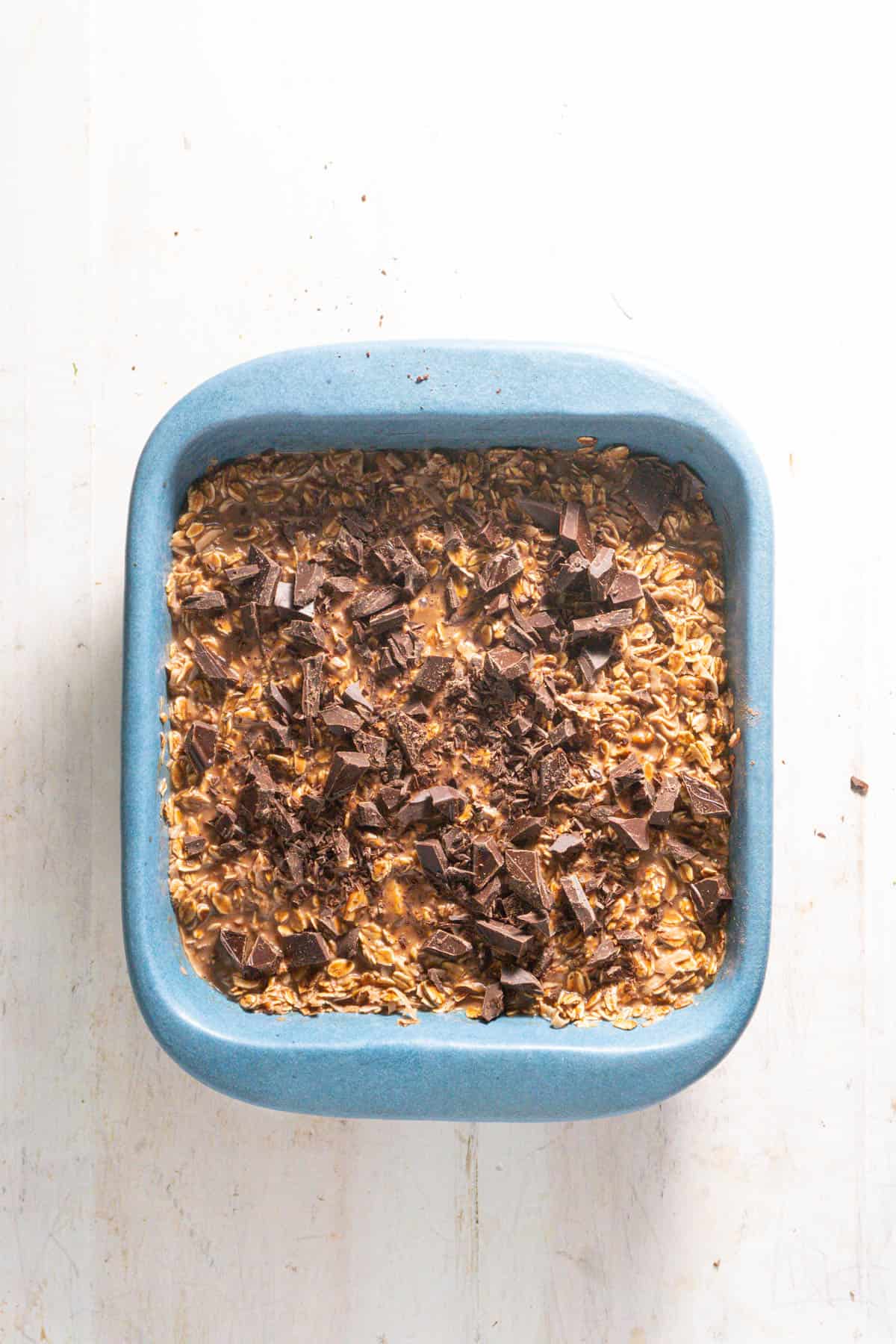 A german chocolate caked topped with chopped chocolate ready to get baked.