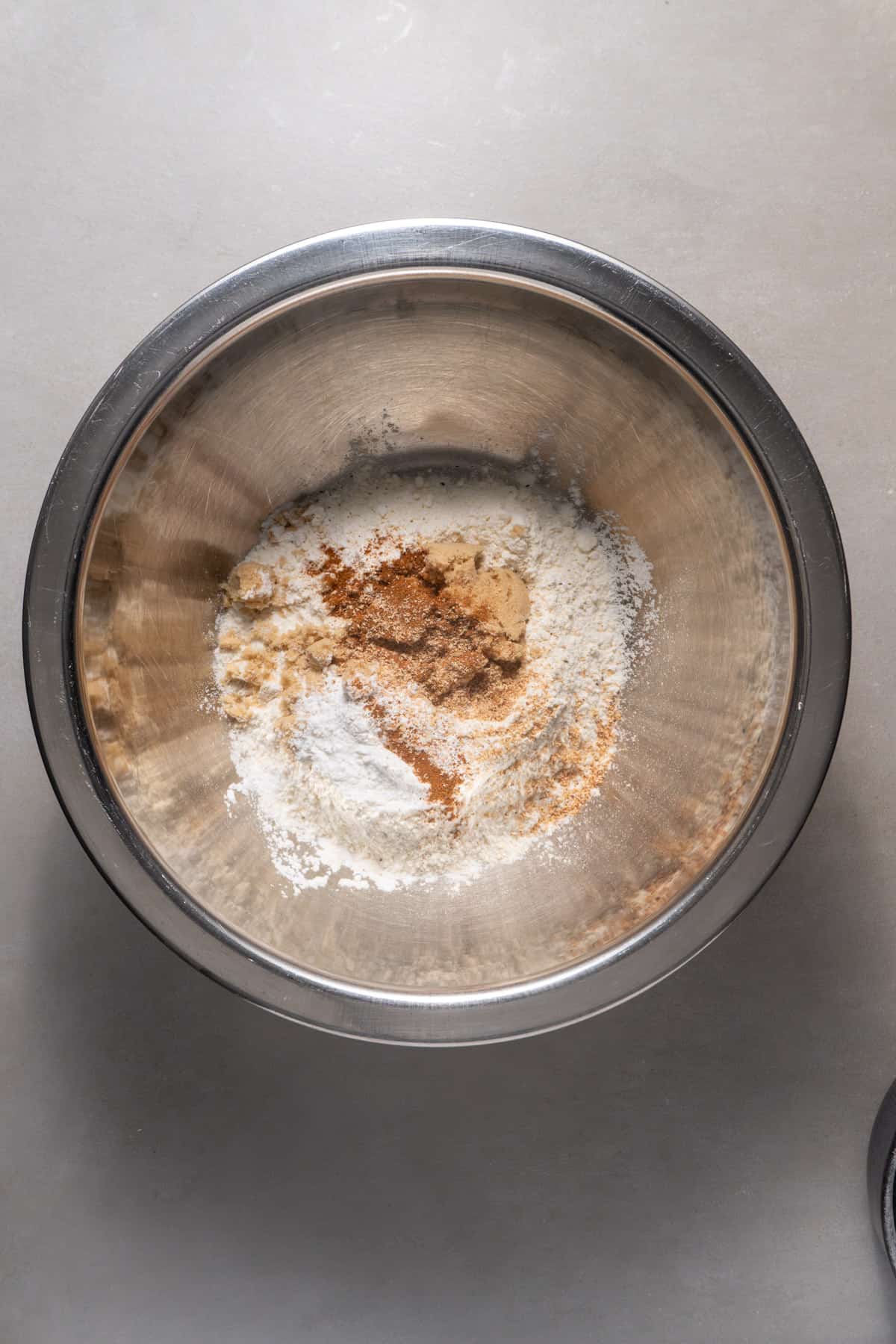 The dry ingredients for brown butter apple pancakes in a medium bowl.