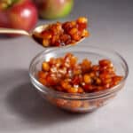 A small bowl of caramelized apples on a gray table.