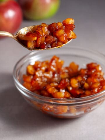 A small bowl of caramelized apples on a gray table.