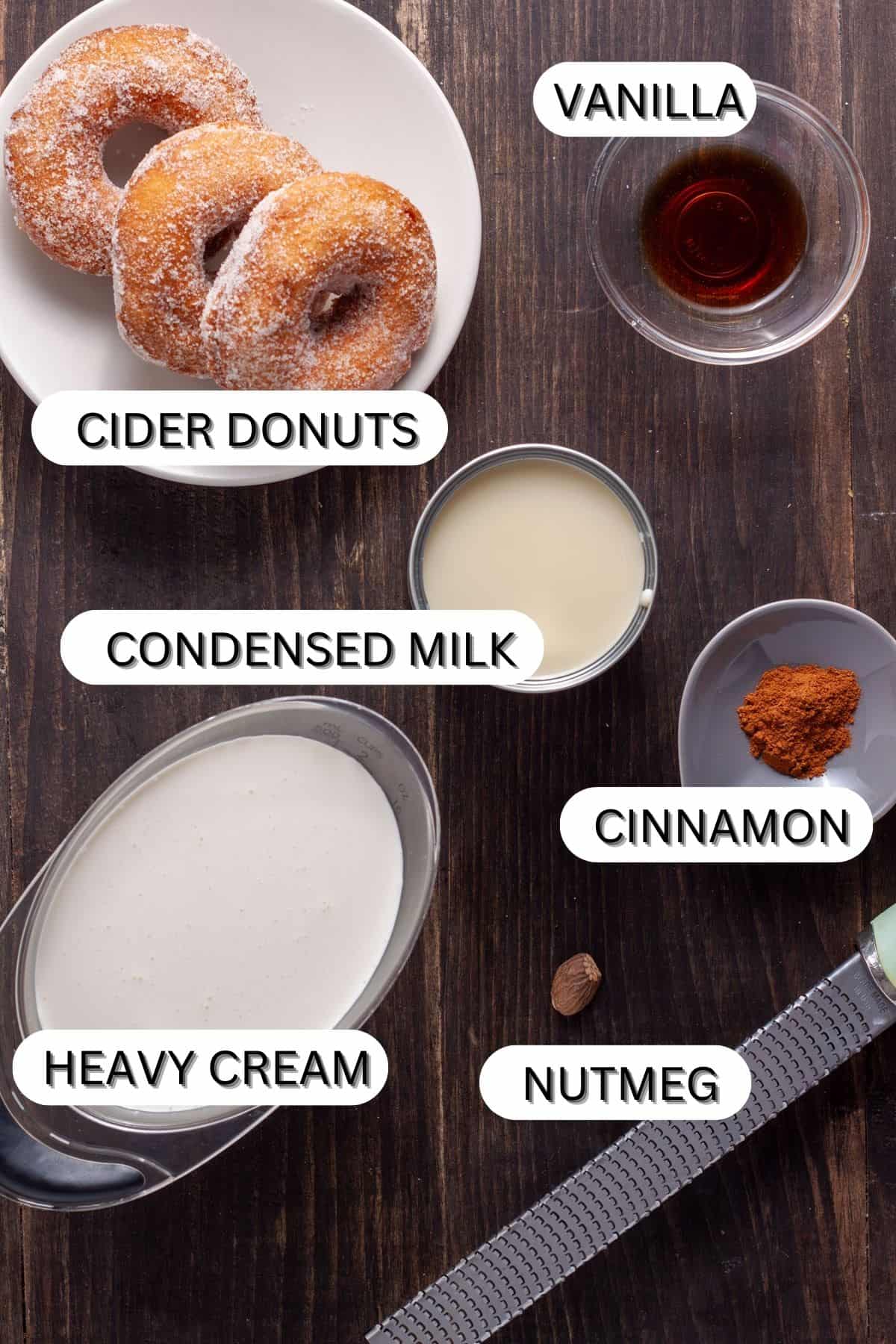 Ingredients for a cider donut ice cream on a dark table.