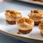 Mini biscoff cheese cakes on a small plate.