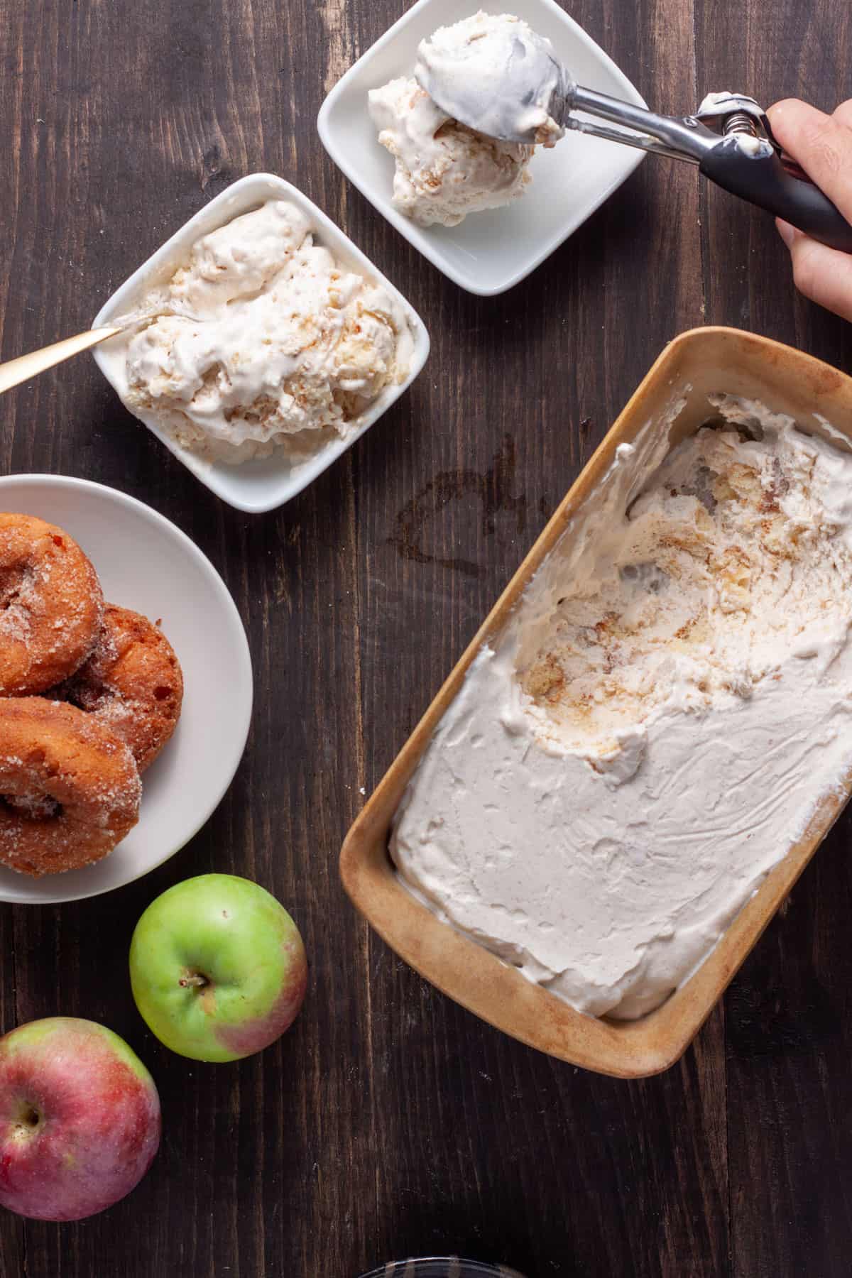 No-churn cider donut ice cream getting scooped into a small bowl.