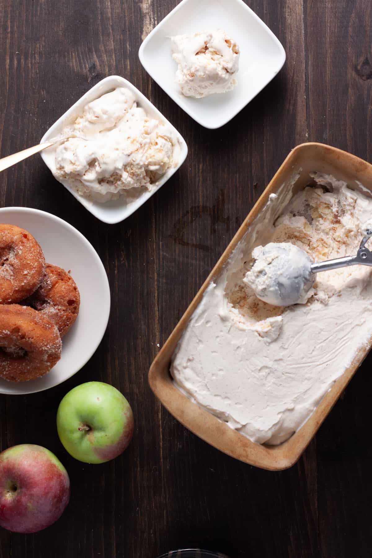 Cider Donut Ice Cream getting scooped out of a pan and served in small dishes.