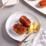 A small plate of tuna croquettes along with homemade tartar sauce.