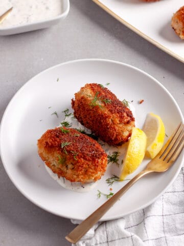 A small plate of tuna croquettes along with homemade tartar sauce.