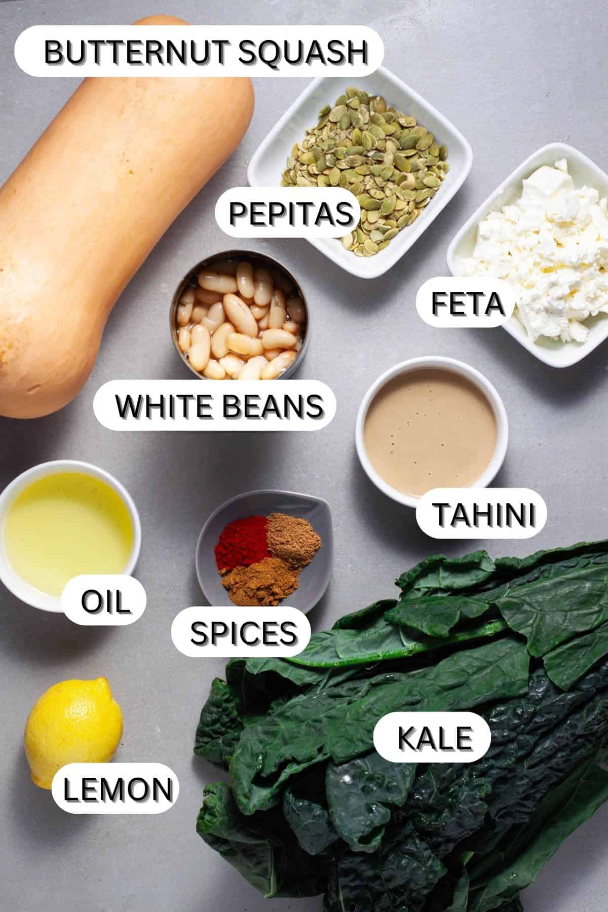 Ingredients for butternut squash and feta salad on a gray table.