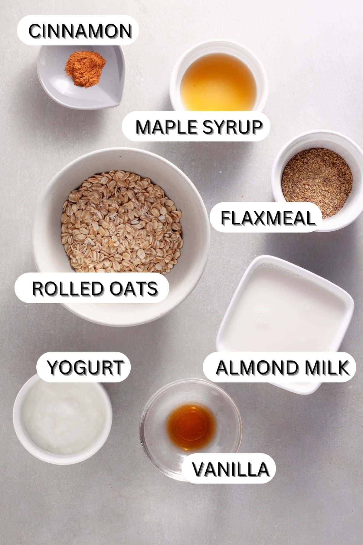 Ingredients for cinnamon overnight oats on a gray table.