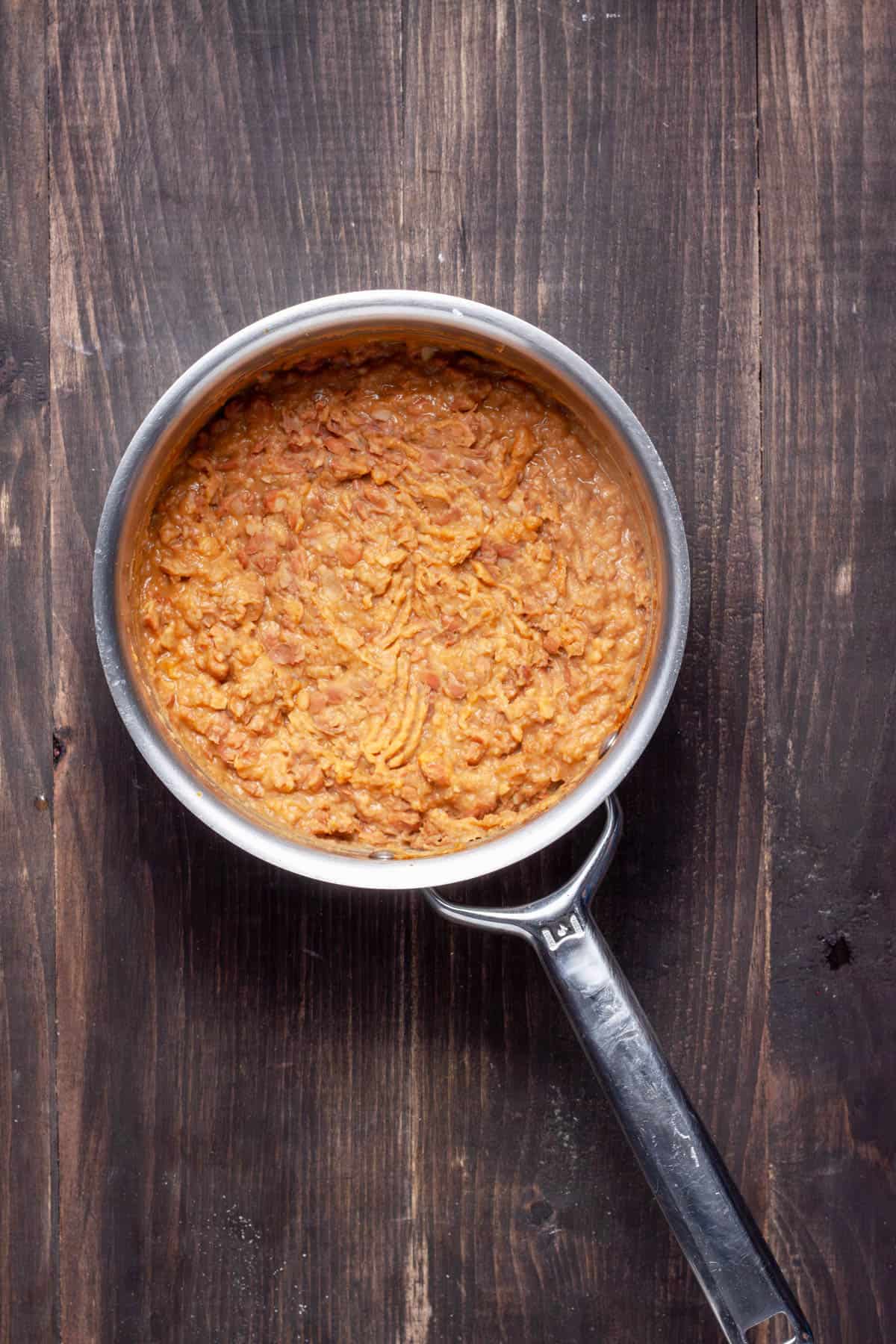 Vegan refried beans in a medium saucepan.